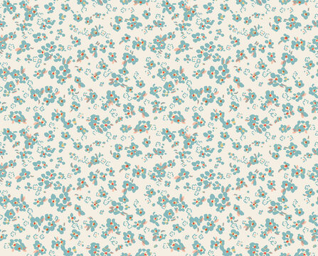 Ditsy floral seamless pattern in blue and peach on a cream background. Cute small meadow flowers. Delicate botanical illustration for spring fabric, wallpaper, or romantic textile design.
