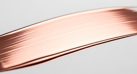 A strand of shiny copper wire isolated on white background, showing fine parallel lines and a smooth texture