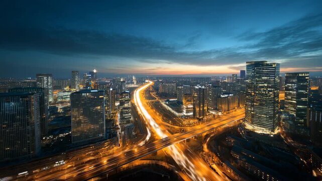 Modern city skyline at dusk with illuminated highway and skyscrapers