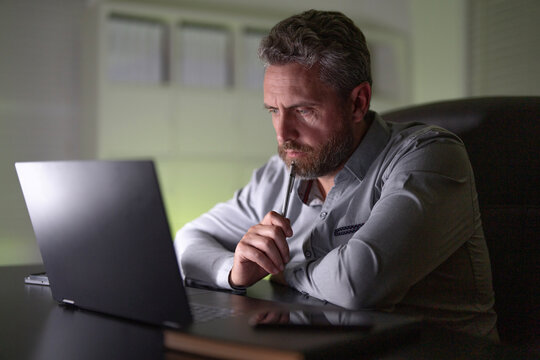 Businessman working late at night. Overworked employee. Freelancer is tired and bored. Office worker frustrated. Entrepreneur feeling stressed about business problems. Office worker with headache. - Powered by Adobe