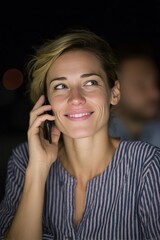 Fototapeta premium Smiling woman, European descent, chatting under moonlit sky, embodies digital nomad dreams, Lunar New Year, and World Smile Day