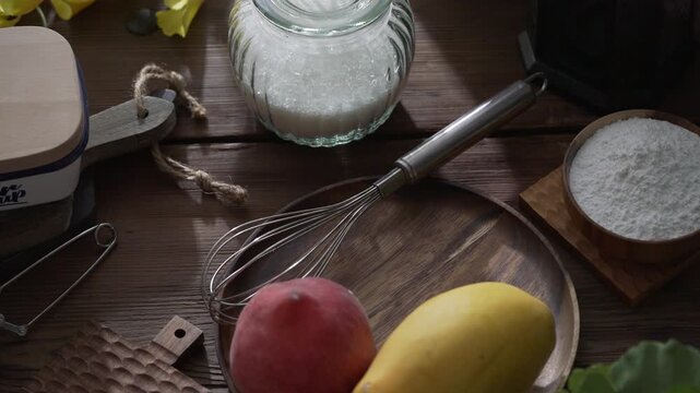 Fresh Baking Ingredients with Milk Pitcher and Fruits on Wooden Kitchen Counter