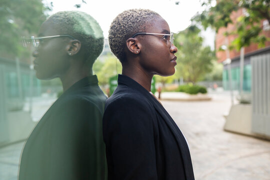 Confident businesswoman reflecting on future success