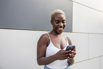 Businesswoman using smartphone outside office