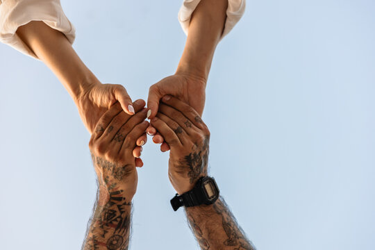 Couple holding hands under the clear blue sky in Turkey
