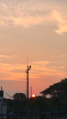 Beautiful Golden Sunset Sky with Urban Silhouette and Street Light Pole