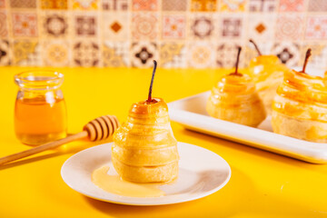 Pears in puff pastry dough drizzled with honey. Healthy and organic food.