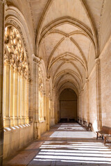 The Segovia Cathedral interior showcases towering Gothic arches and an ornate vaulted ceiling. Massive columns frame the central altarpiece and detailed stained glass