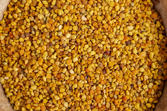 Top view of organic bee pollen on wooden surface