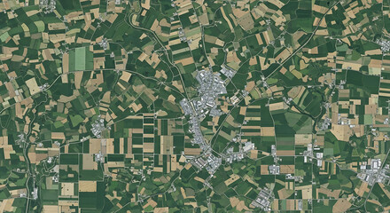 Fototapeta premium Aerial View of a City Surrounded by Diverse Agricultural Fields and Rural Landscapes