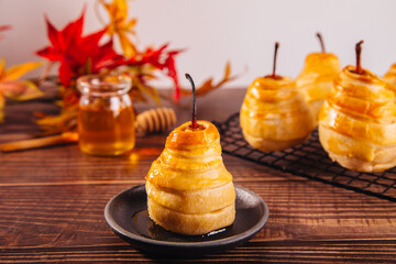 Pears in puff pastry dough drizzled with honey. Healthy and organic food.