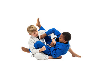 Kids sparring in Brazilian jiu-jitsu wearing blue and white gi isolated PNG
Children training ground fighting technique in BJJ on transparent background