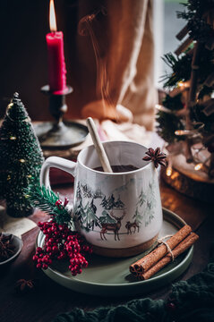 Festive mug with mulled wine and Christmas decorations