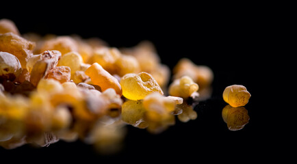 Frankincense olibanum resin, Boswellia sacra Isolated on black background. Frankincense or olibanum...
