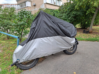 Cover on a motorcycle parked near a house © Harmony Video Pro