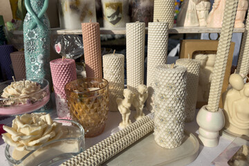 A showcase with handmade natural candles for various events: dates, weddings, comfort