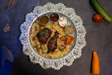 Tandoori Chicken and Basmati Rice with Fresh Cilantro and Lime in plate top view of bangladeshi food