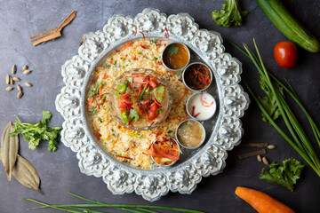 Vegetable Curry Served Over Pulao Rice on Silver Platter top view of bangladeshi food