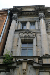 the facade of a building with columns and bas-reliefs above the window