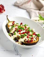 Roasted eggplant stuffed with couscous, feta and pomegranate