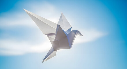 A white paper crane flies against a bright blue sky.
