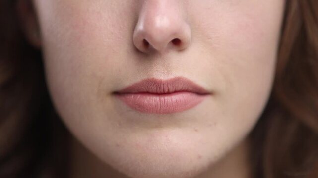 A woman's face with a thin nose and lips