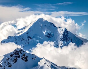 Majestic snowy mountain peak rising above fluffy, white clouds and blue sky