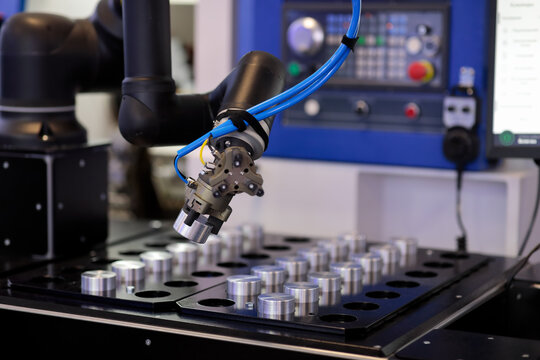 robot manipulator loads workpiece in CNC machine