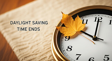 Golden autumn leaf on clock face text Daylight Saving Time Ends fall