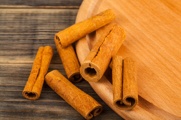 Cinnamon on wooden background.