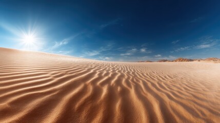 The expansive desert scene showcases gentle, flowing sand dunes under a vibrant blue sky, capturing the essence of solitude and the beauty of nature's patterns.