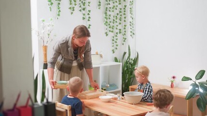 Kindergarten children watch instructor preparing for baking as she sets tray on table, guiding young girl while others observe activity, creating warm educational and interactive classroom moment - Powered by Adobe
