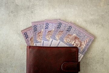 Malaysia money. Malaysian ringgit banknotes sticking out of the wallet. Currency MYR. Business and financial concept. close up