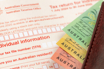  Australian tax return document to fill out and money. Financial concept. Tax settlement, Australian dollars. close up. Business background