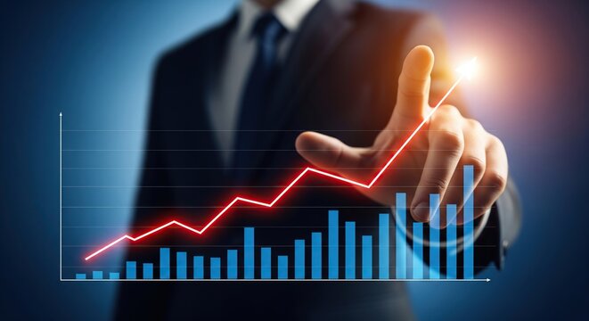 Businessman s hand pointing to a rising red line graph showing positive financial growth and success