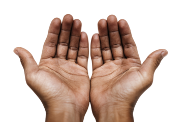 Two dark-skinned hands, palms up, in supplication against a black background.  Detailed view of the lines and texture of the skin on the palms and fingers