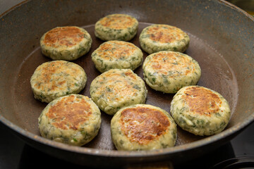 Cottage cheese pancakes or fritters with herbs, green onions, and parsley. Cottage cheese pancakes with dill on a plate. A healthy breakfast or a dietary lunch. Copy space.