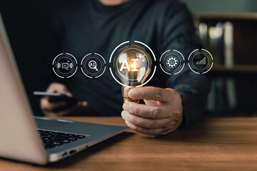 person hold a glowing light bulb with AI icon hovering above a laptop, symbolizing artificial intelligence innovation, smart technology, and creative ideas driving digital transformation and progress.