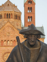 Speyer - Jakobspilger, Bronzefigur vor unscharfem Speyerer Dom, Rheinland-Pfalz, Deutschland, Europa