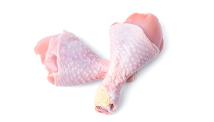 A studio shot features two raw chicken drumsticks, pale pink with visible skin textures, against a clean, white background. The lighting is soft and even