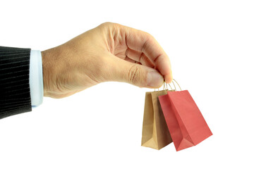 Man hand carries  mini shopping bags on white background.