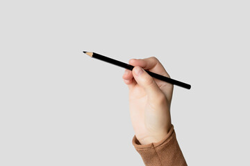 Hand Holding a Black Pencil Ready to Write or Draw