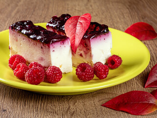 Delicious pastries filled with raspberry jam and fresh raspberries on a plate