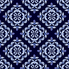 A seamless hand-drawn Baroque pattern with ornate white and blue Acanthus scrollwork on a  navy blue background. Ideal for luxury textile,  wallpaper and decoration
