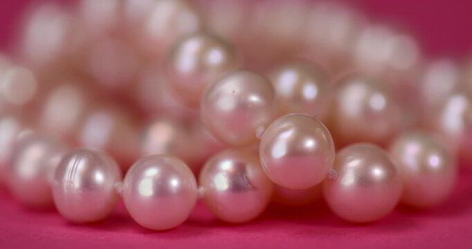 natural unpolished irregular shaped pearls from a marine mollusk used in the manufacture of jewelry beads, a necklace made from natural pearl beads strung on a string