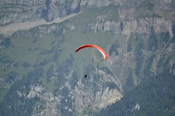 Paragliding over Interlaken, Switzerland, with the Alps in the background