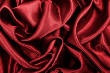 Smooth elegant red silk or satin luxury cloth texture as abstract background. Luxurious valentines day background design