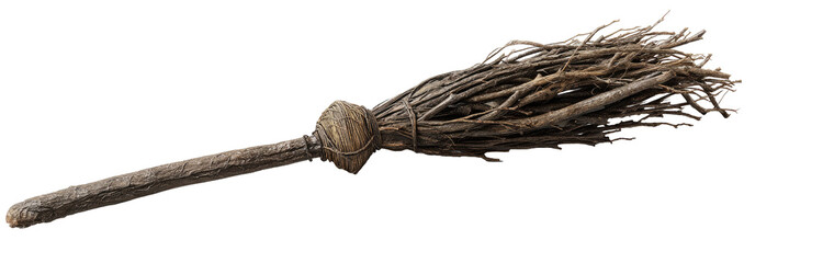 A rustic, dark-colored broom, with a bundled, twig-like head attached to a long, wooden handle