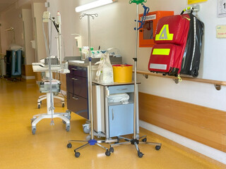 Hospital corridor with medical carts, emergency defibrillator, clinical environment, healthcare...