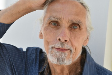 portrait of an elderly man with gray hair and a beard